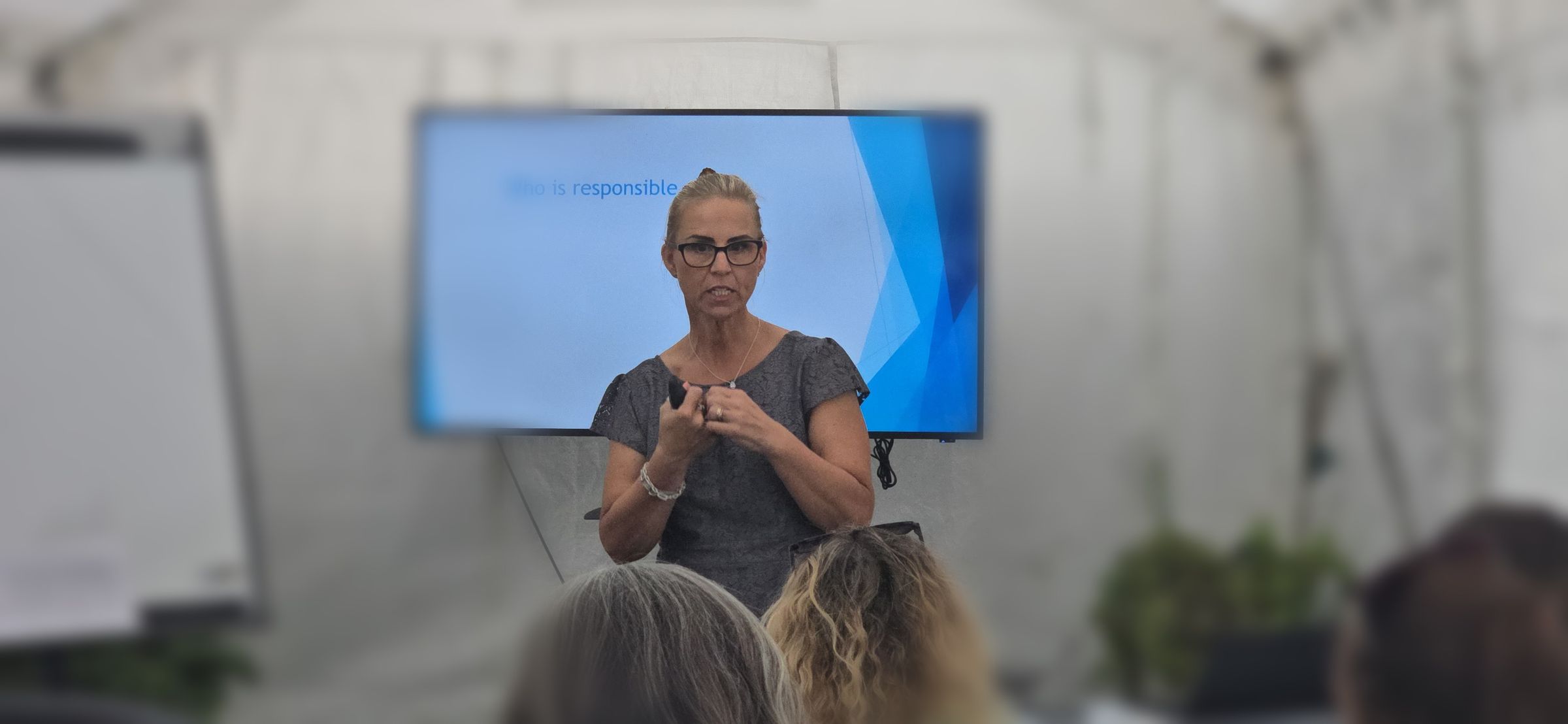 Tracie engaging with the group during a workshop discussion